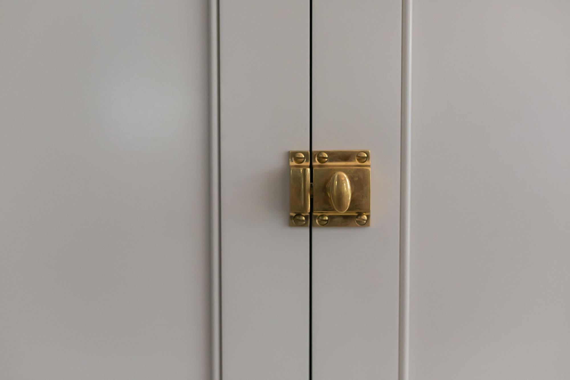 Gray painted shaker cabinet doors with brass knobs and marble countertop — J. Arthur Custom Homes kitchen